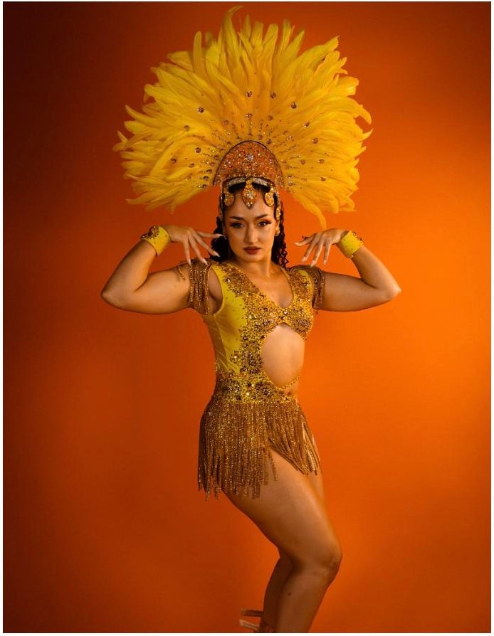Michela Melone in a gold samba costume and feathered headdress